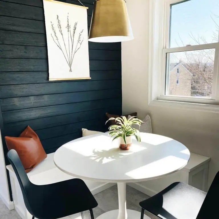 Black shiplap wall with chairs