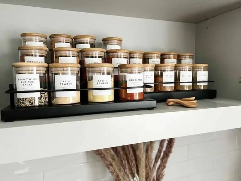 Black spice rack on white shelf