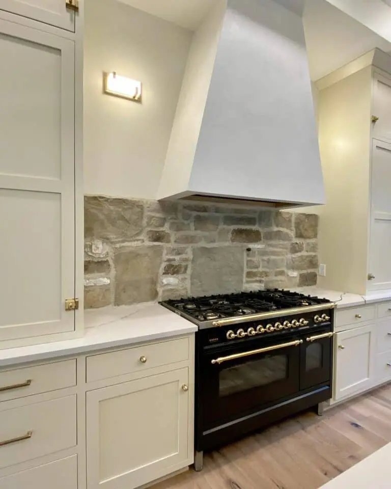 Cream cabinets stone backsplash