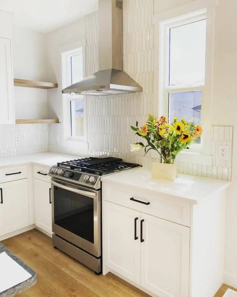 White cabinets with hexagon tile backsplash